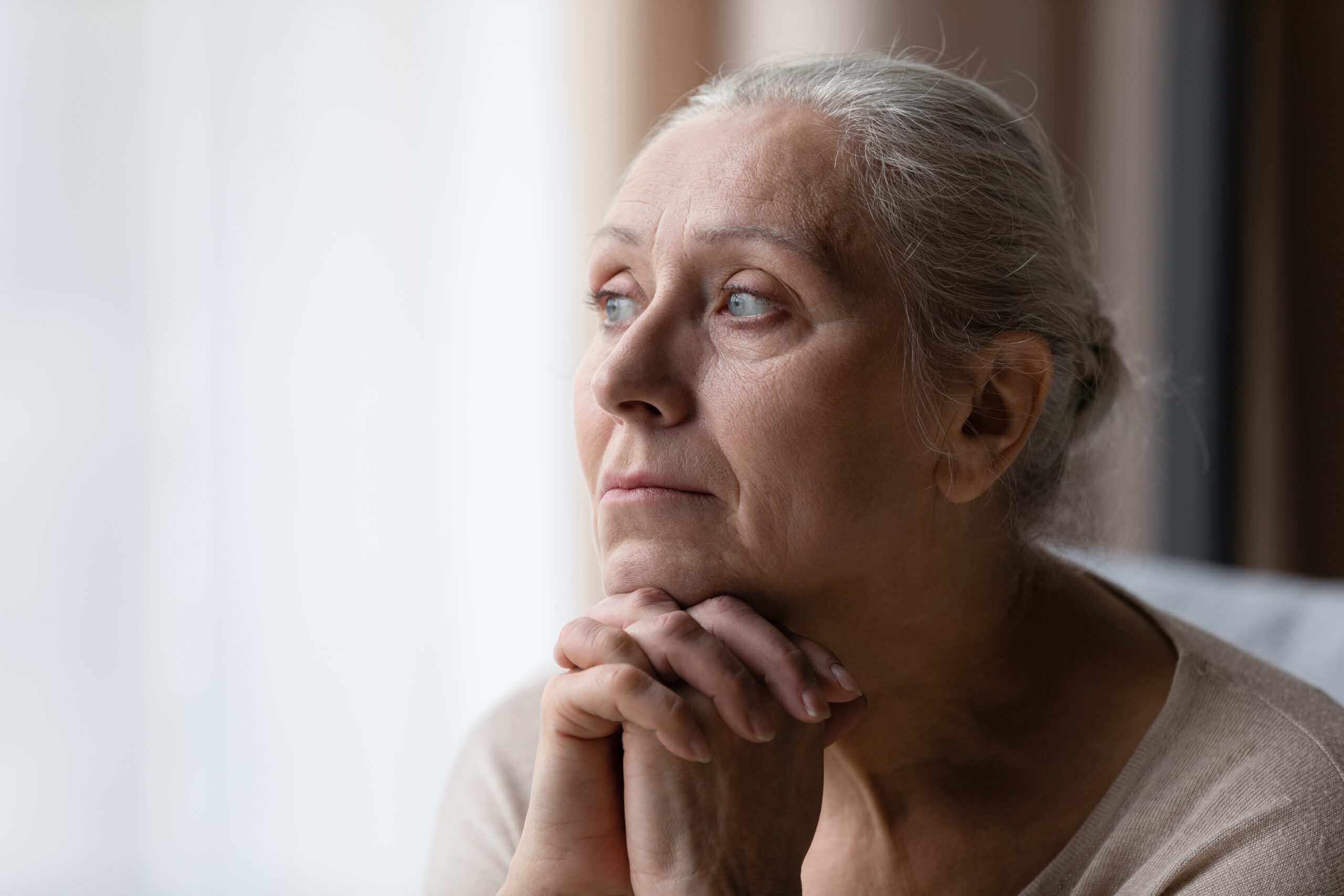 Older woman reflecting on loss