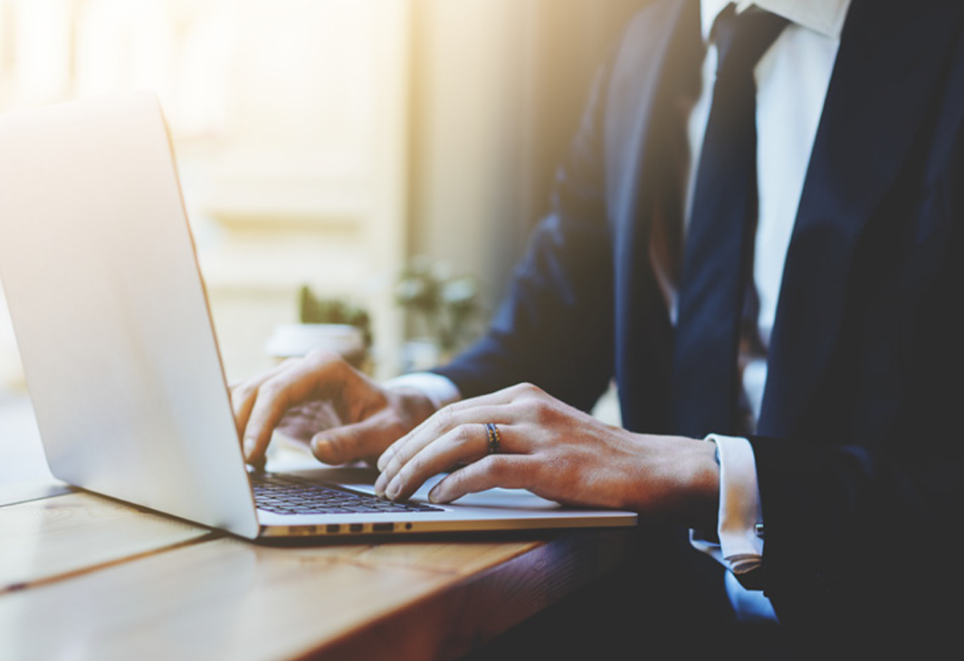 Technology solutions funeral home enterprise person at keyboard
