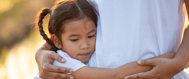 grief after natural disaster little girl hugging person