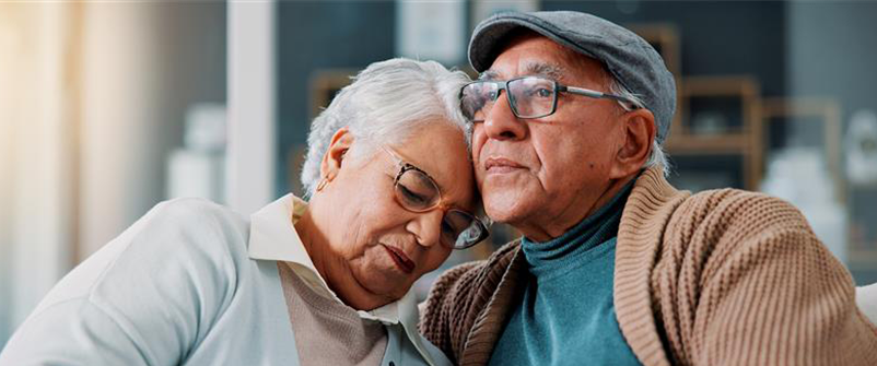 couple leaning into each other grieving